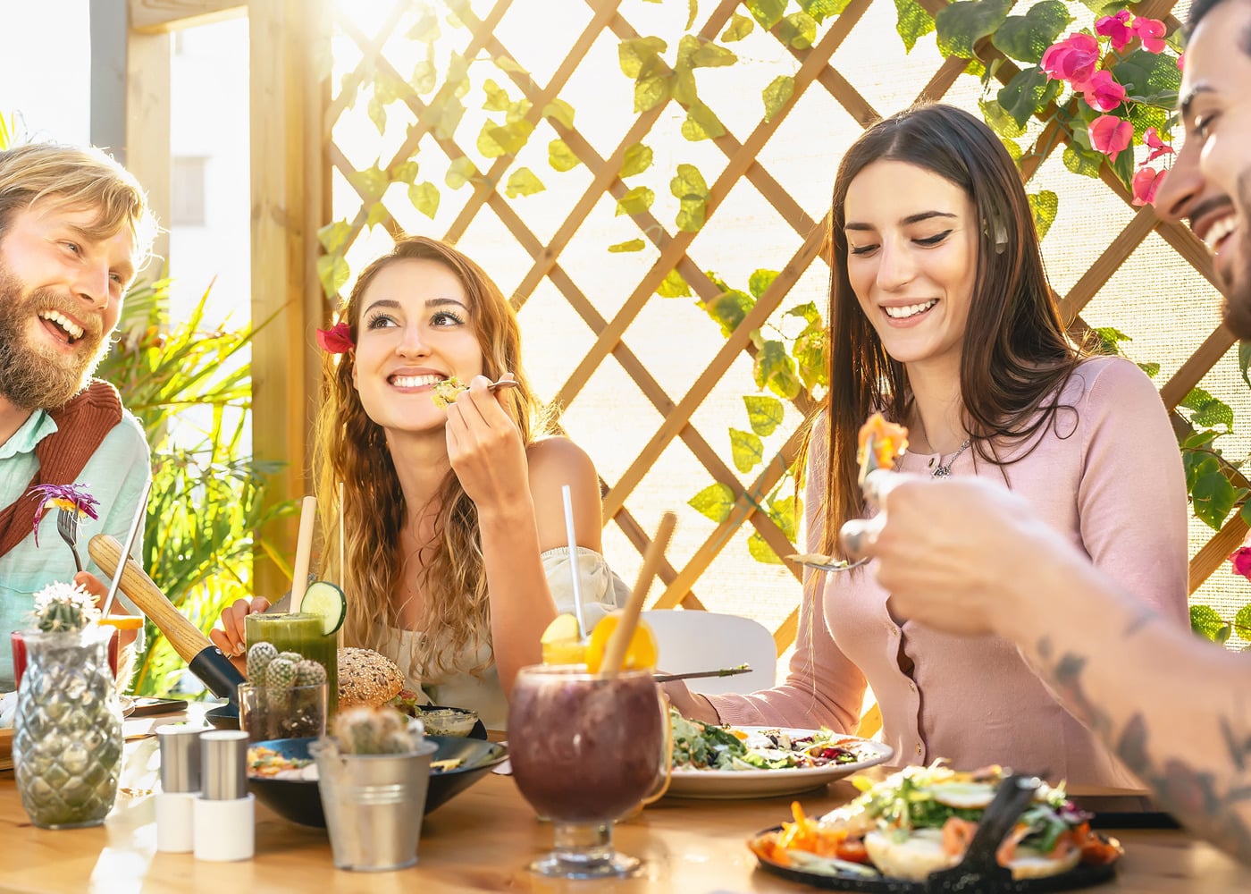 Friends Enjoying Lunch Outside Together at the New Summer Table