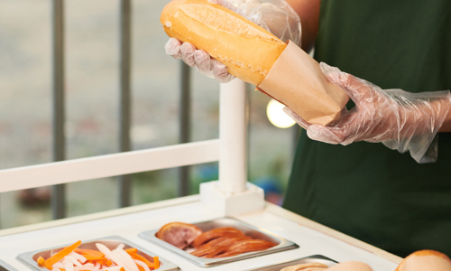 vendor-putting-sandwich-in-cardboard-package-2021-12-14-20-12-23-utc.jpg