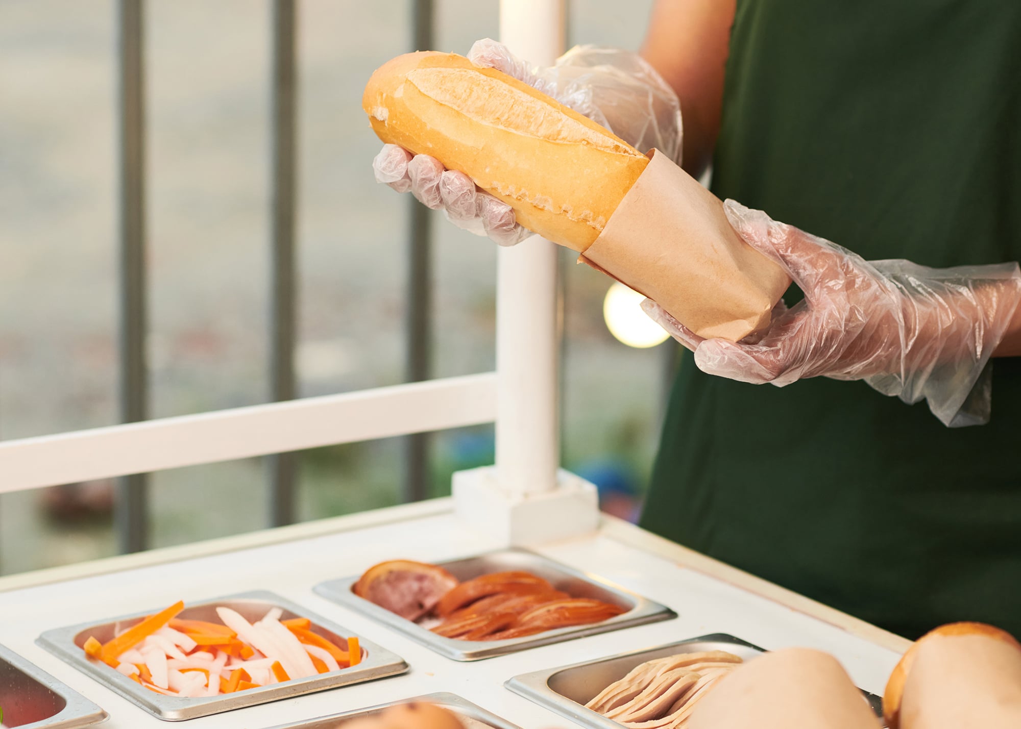 vendor-putting-sandwich-in-cardboard-package-2021-12-14-20-12-23-utc.jpg