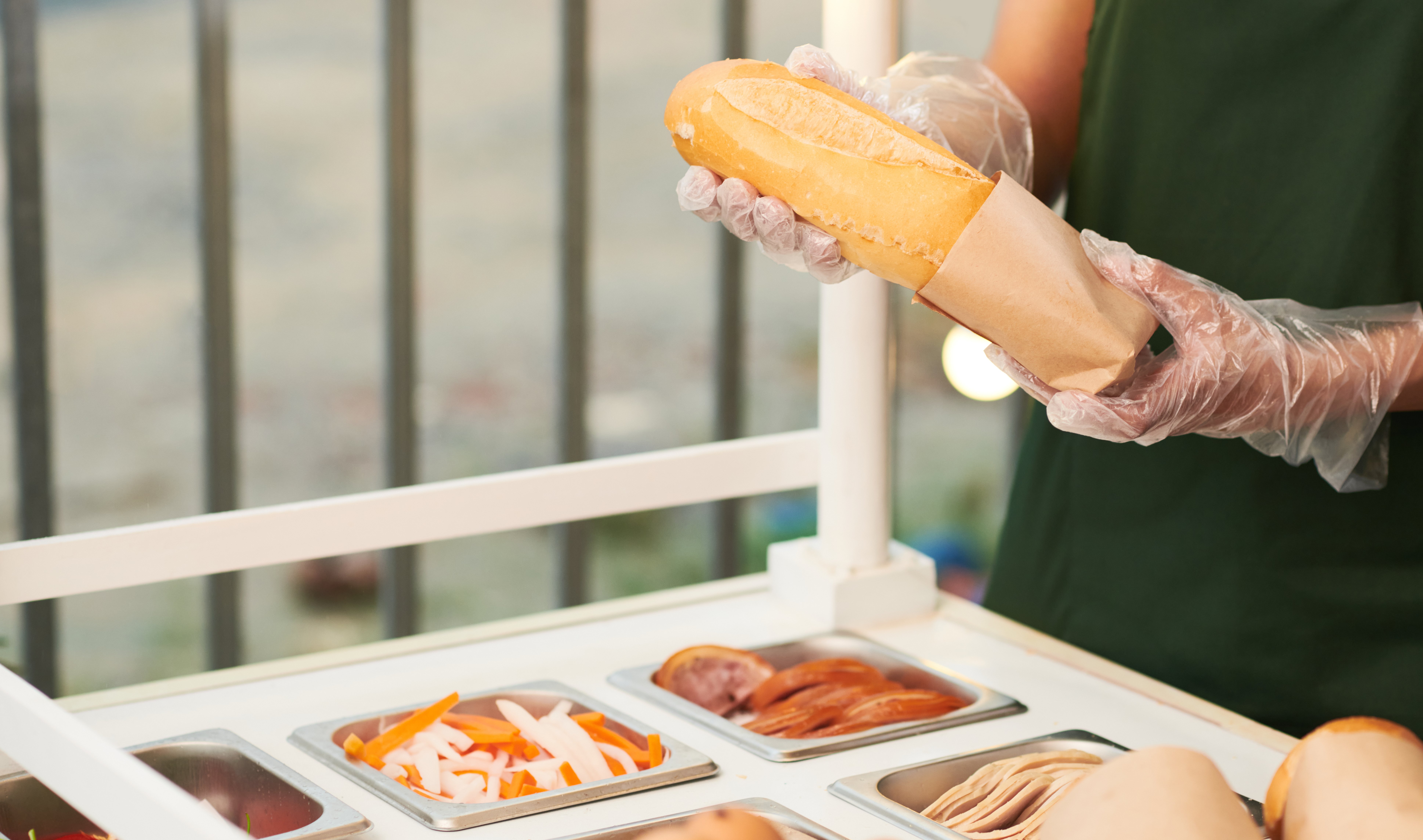 vendor-putting-sandwich-in-cardboard-package-2021-12-14-20-12-23-utc.jpg